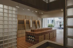 Modern retail storefront featuring wood, glass, and tiled surfaces.