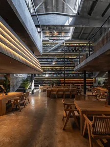 A spacious, industrial-style library with concrete, wood, and glass elements.
