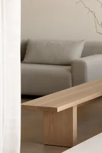 A minimalist living room featuring a wooden coffee table.
