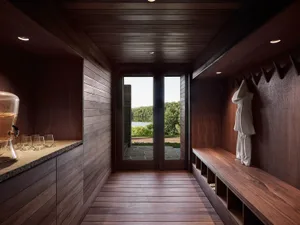 A minimalist entrance featuring wooden walls and flooring.