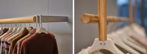 Bamboo clothing rail mounted on a metal bracket in an interior setting