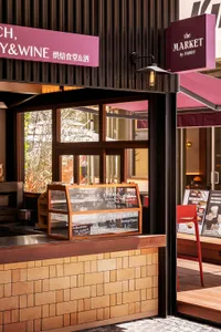 A modern brick storefront with a glass display case and signage.