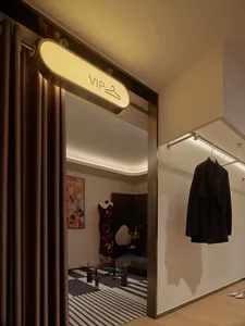 A luxurious VIP room with metallic textures in a high-end retail setting.