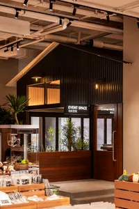 A modern event space entry with corrugated metal cladding and glass windows.