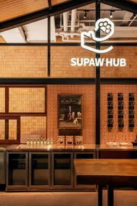 A storefront with a brick facade featuring industrial elements.