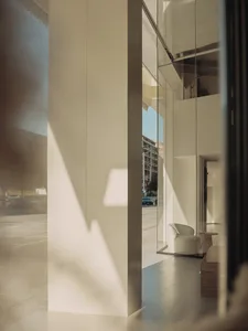 A minimalist retail storefront featuring glass doors.