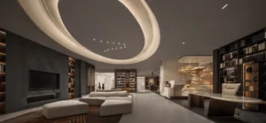 Modern lobby with concrete walls and furniture, featuring a curved ceiling with embedded lights.