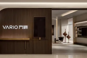 A modern office reception area with a wooden accent wall and minimalist design.