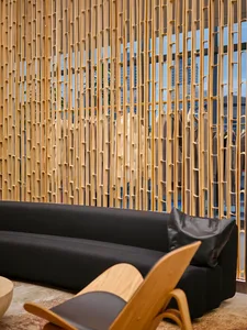 Modern retail store with a timber wall and black sofa.