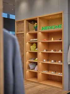 Modern retail storefront with wooden shelves displaying home goods and accessories