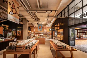 A spacious pet shop interior with various sections for pet supplies and accessories.