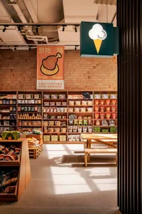 A pet supply store with wooden shelves displaying various products on a brick wall background.