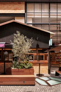 A retail storefront with wooden panels and glass windows.