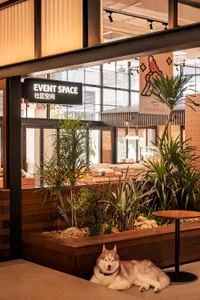 A cozy event space with wooden accents and glass walls.