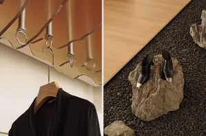 Industrial-style clothing display with metal hooks and wooden elements.