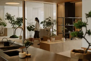A modern office space with minimalist design featuring concrete and wooden elements.