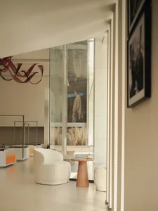 Modern, minimalist retail stall with glass display cases and concrete counter