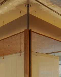 Modern interior design featuring wooden accents, concrete walls, and steel structural elements.