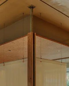 A modern interior design featuring wooden panels and a metallic beam structure.