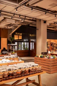 A retail storefront with a modern design featuring a wooden counter