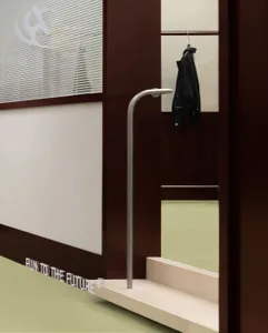A metal clothing rack hanging in a modern industrial-style room.