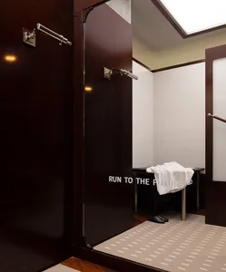 Modern minimalist clothing fitting room with metal and glass materials