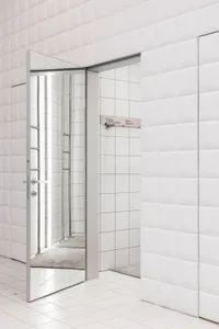 Modern minimalist bathroom with glass walls, metal accents