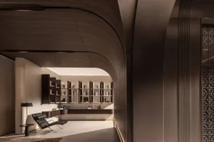 A minimalist interior design featuring a modern bookshelf nook with a comfortable lounge chair and a sleek floor lamp.
