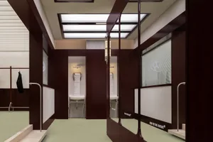 A modern gym interior showing walls with metal fittings and reflections on the floor.