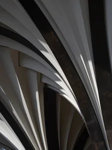 Modern architectural detail with metallic, glass, and concrete materials.