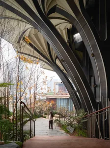 A modern architectural structure featuring large, curved metal arches.