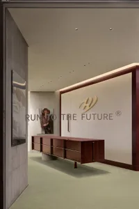 Modern office space featuring metallic furniture on green carpeting.