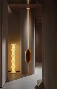 Modern minimalist interior space featuring contemporary floor lamps with abstract geometric shapes.