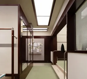 An office space featuring modern architectural elements such as glass doors, wood accents, and concrete flooring.