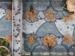 Overhead view of a modern public space featuring decorative tiles, concrete walkways, and wooden structures.