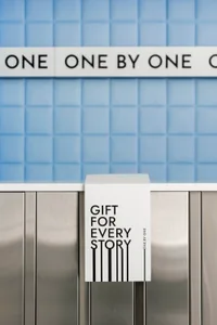 A metal and tile storefront with signage reading 'Gift for Every Story'.