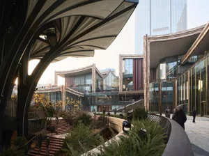 A modern urban architectural design featuring glass, steel, and concrete materials.