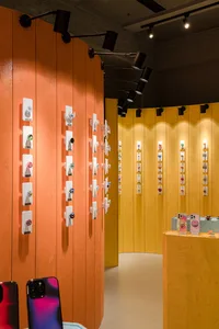 Phone accessories shop featuring metallic aluminum displays and design elements.