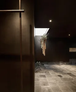 An industrial-style interior design featuring metal walls and stone flooring.