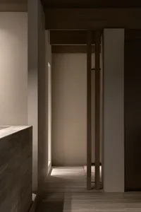 A sleek, minimalist bathroom with concrete walls and floor.