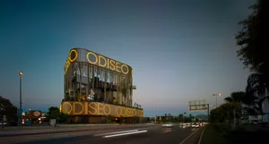 Modern building with illuminated signage and lights at dusk