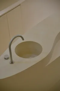 A minimalist bathroom with a contemporary design using concrete materials.