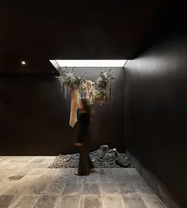 A minimalist space with concrete walls and a skylight.