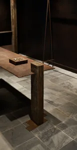 Minimalist console table made of steel with a wooden pillar