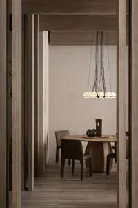 A modern dining room featuring a wooden table with a unique chandelier and chairs.