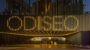 A modern entrance adorned with illuminated metal panels and bright lights.