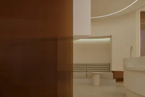 A modern interior featuring a concrete seating area with minimalist design.