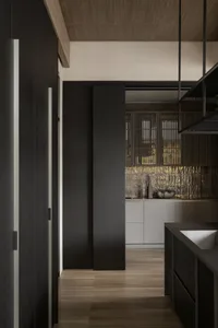 A modern kitchen with dark wooden cabinetry and tiled flooring.
