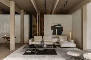 Modern minimalist living room featuring a white sectional sofa, black coffee table, and wooden columns.
