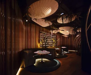 A modern restaurant interior featuring wooden elements and contemporary design.